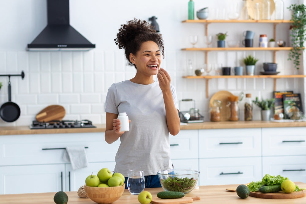 happy african american woman standing cuisine taking kanna extract